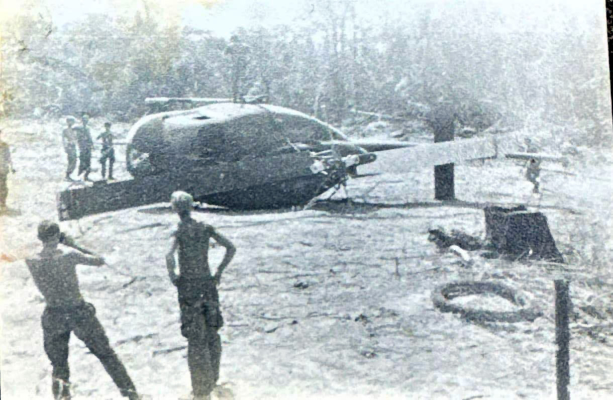 A downed Cobra gunship near a firebase in mid-summer in 1971.