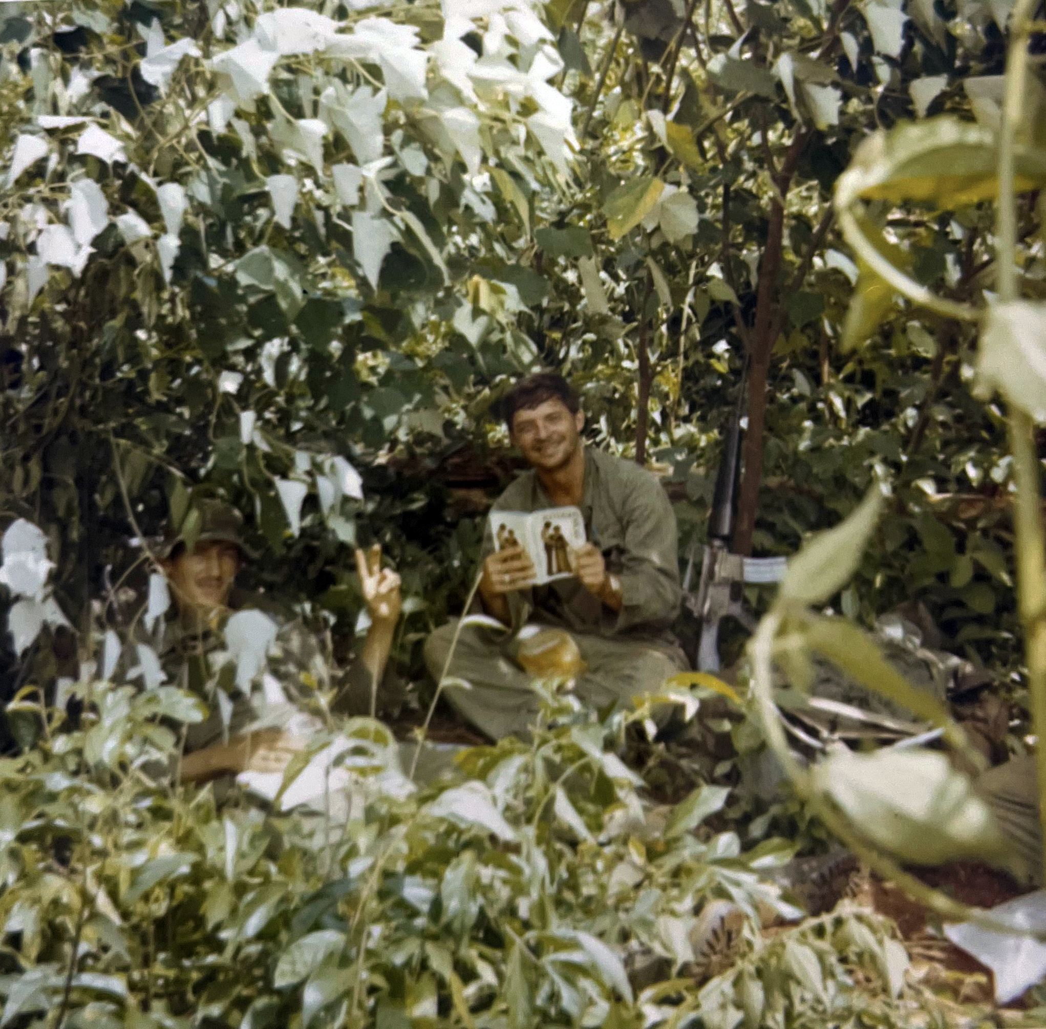 GIs reading a magazine during downtime in the bush in 1971.
