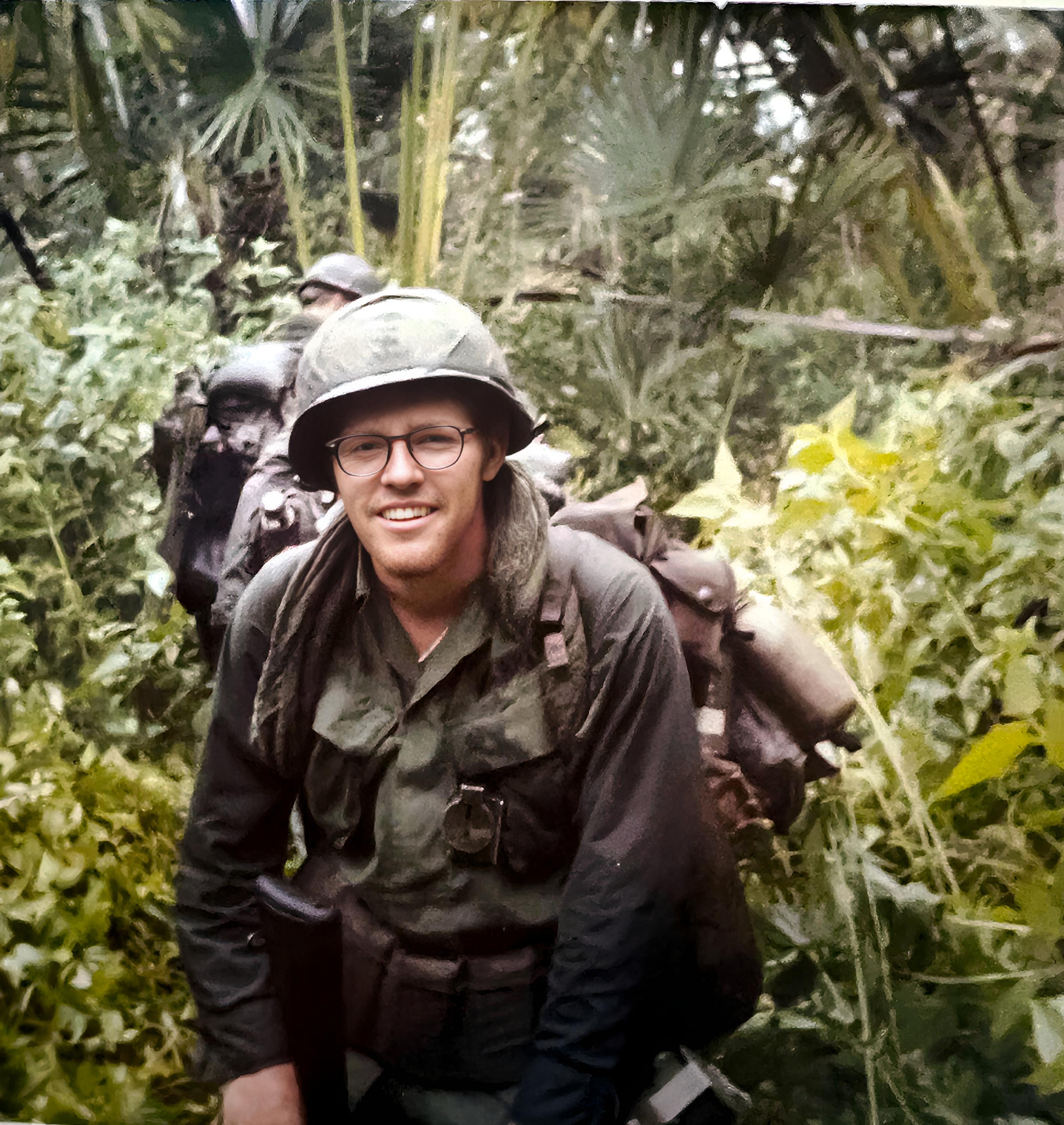 Marvin Miller on the move in the bush, during what looks like rainy season