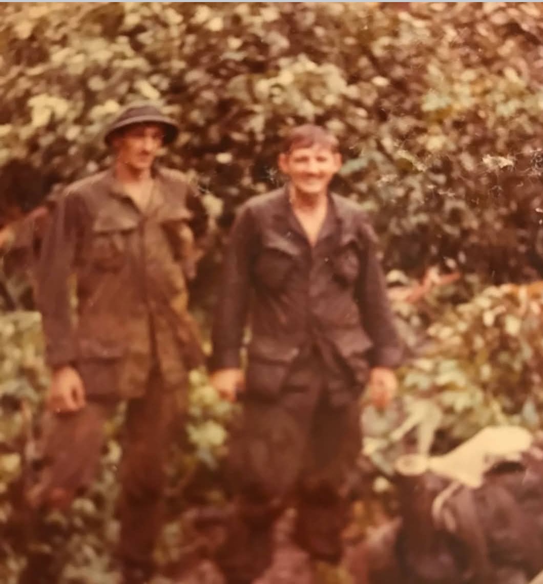 Dennis Alloway (R) and Dale Tincher in the bush during rainy season.