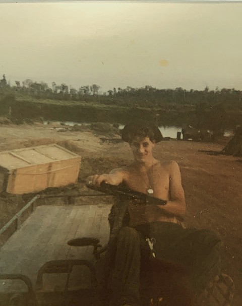 Thomas Wood with a military vehicle